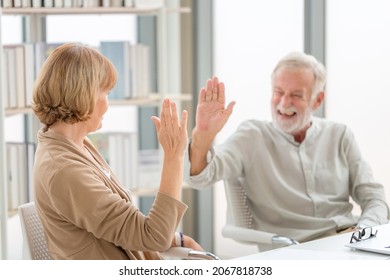 Happy Senior Couple In Living Room, Smiling Older Couple Giving High Five, Happiness Family And Retirement Concepts