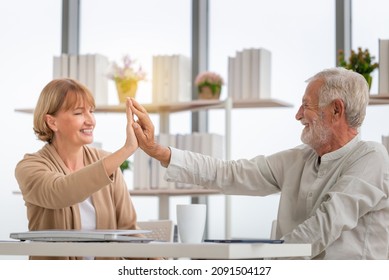 Happy Senior Couple In Living Room, Smiling Older Couple Giving High Five, Happiness Family And Retirement Concepts