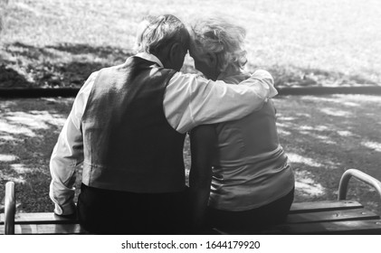 Happy Senior Couple Love Story. Old Couple Is Walking In The Green Park. Grandmother And Grandfather Laughing. Elderly People Lifestyle. Together Pensioners. Soft Focus Photo.