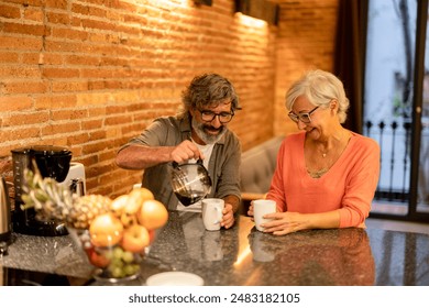 Happy senior couple making coffee and smiling in a cozy kitchen with a brick wall background. - Powered by Shutterstock