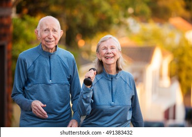 Happy Senior Couple In Matching Blue Athletic Outfits Together Outside