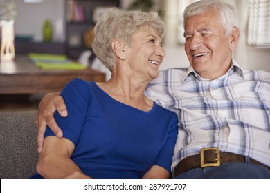Happy Senior Couple On Te Sofa