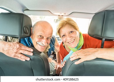 Happy Senior Couple Ready For Driving Car On Journey Trip - Concept Of Joyful Active Elderly With Retired Man And Woman Enjoying Their Best Years - Modern Mature Travel Lifestyle During Retirement