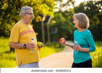 Happy senior couple is ready for exercising in park. - Powered by Shutterstock