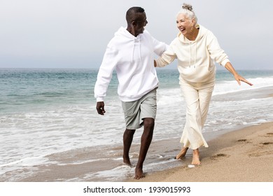 Happy senior couple relaxing at the beach in winter