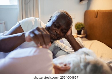 Happy senior couple relaxing in bed at morning - Powered by Shutterstock