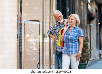 Happy Senior Couple With Shopping Bags