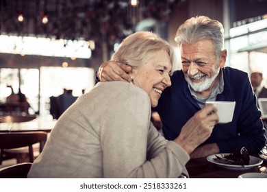 Happy senior couple sitting in a cafe