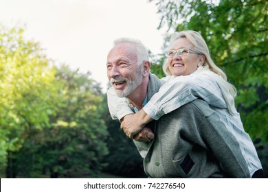 Happy senior couple smiling outdoors in nature 