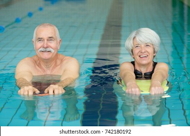 Happy Senior Couple In Swimming Pool