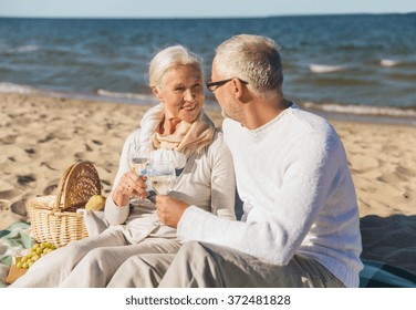 happy senior couple talking on summer beach - Powered by Shutterstock