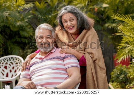 Happy senior couple together spending time at home garden