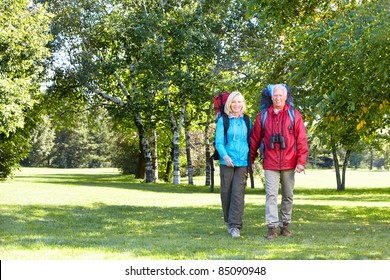 Happy Senior Couple Walking With Backpacks. Adventure.