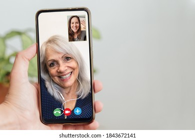 Happy Senior And Daughter Talking On Video Call With Mobile Phone During Coronavirus Outbreak - Online App And Social Distancing Concept