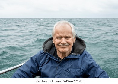 Happy senior enjoying retirement in the nature on a boat. - Powered by Shutterstock