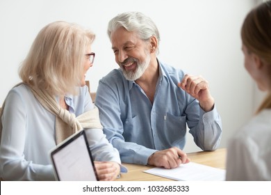 Happy senior family talking smiling at meeting with financial advisor, older clients ready to buy medical health life insurance consulting broker, aged retired couple real estate deal about to sign 
