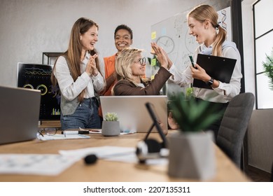 Happy Senior Female Leader In Formal Wear In Business Office, Giving High Five To Her Colleague As Celebrating Success, Unity Or Starting New Project. High-five For Success.