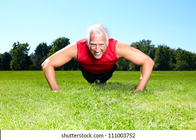 Happy senior fitness couple in the park. - Powered by Shutterstock