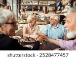 Happy senior friends eating at a cozy bistro together