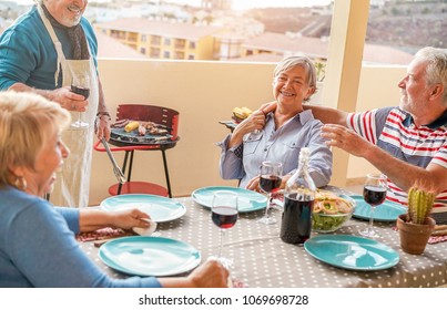 Happy Senior Friends Having Fun At Barbecue Dinner In Patio Outdoor - Mature Old People Dining And Drinking Wine At Bbq Meal - Focus On Right Woman Face - Joyful Elderly Lifestyle And Summer Concept