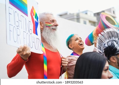 Happy Senior Gay Man Holding Banner At Pride Lgbt Festival - Focus On Left Face