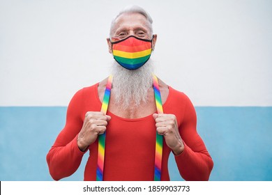 Happy Senior Gay Man Wearing Rainbow Flag Mask At Lgbt Parade - Focus On Face