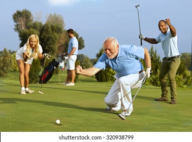 Happy senior golfer following golf ball to hole after putting.