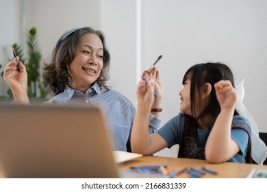 Happy Senior Grandma And Cute Little Kid Granddaughter Watching Cartoons On Laptop Together, Happy Older Grandmother Grawing And Painting.