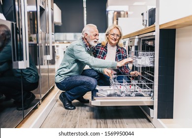 Happy Senior Husband And Wife Buying Household Appliances In Store.
