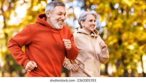 Happy senior husband and wife in sportive outfits running outdoors in city park, lovely retired couple jogging in sunny morning looking at each other with warmth and smile. Healthy lifestyle concept
 - Powered by Shutterstock