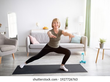 Happy Senior Lady Doing Lunges On Domestic Workout In Living Room, Copy Space. Sporty Mature Woman Leading Healthy Lifestyle, Keeping Fit Or Losing Weight At Home During Covid Quarantine