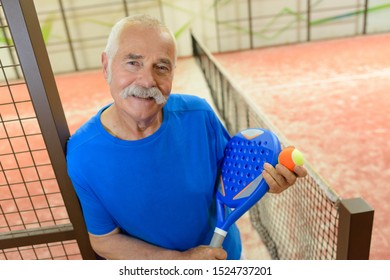 Happy Senior Male Tennis Player Indoors