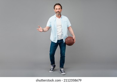 Happy Senior Man With Basketball Ball On Grey Background.