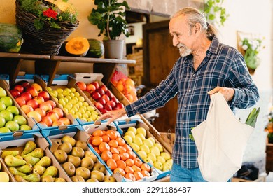 Happy senior man buying fresh fruits at the market - Shopping food concept  - Powered by Shutterstock