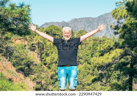 Happy Senior Man Enjoying Trekking Day on Mountain Standing with Open Arms Enjoying Beautiful of Nature - Freedon, Sport, Healthy Lifestyle Concept