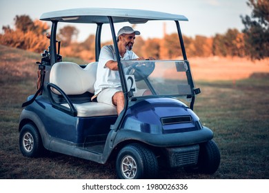 Happy Senior man in golf car. 