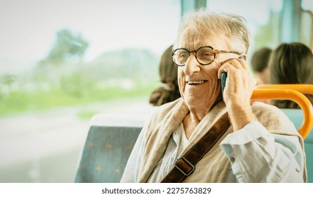 Happy senior man having a call with smartphone while traveling by bus - Powered by Shutterstock