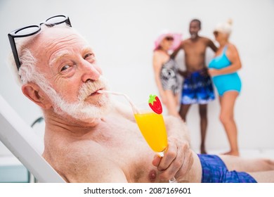 Happy Senior Man Having Party In The Swimming Pool - Active Elderly Male Person Sunbathing And Relaxing In A Private Pool During Summertime