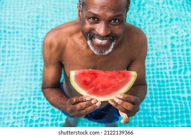 Happy Senior Man Having Party In The Swimming Pool - Active Elderly Male Person Sunbathing And Relaxing In A Private Pool During Summertime