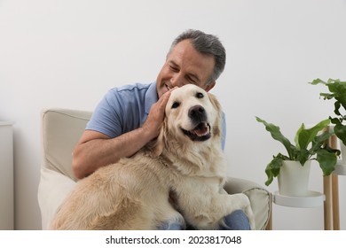 Happy senior man with his Golden Retriever dog at home - Powered by Shutterstock