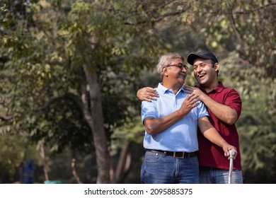 Happy senior man holding walking stick and giving high five to his son at park
 - Powered by Shutterstock