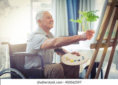 Happy Senior Man Painting At Home