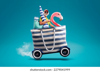 Happy senior man riding a fast bag with wheels and going to the beach, summer vacations at the seaside concept, copy space - Shutterstock ID 2279041999