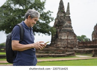 Happy Senior Man Searching Ancient Tourist Attraction From Internet Mobile Phone, Elderly Man Visited Ayutthaya Historical Park,Thailand.concept Older Adult Lifestyle,life, Quality Of Life,travel