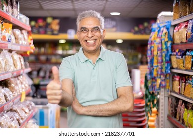 Happy senior man show thumbs up at grocery store products. - Powered by Shutterstock