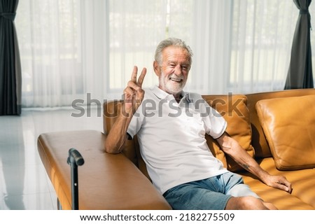 Happy senior man sitting on a sofa at home.retirement happiness