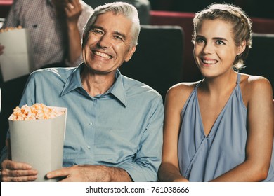 Happy Senior Man Sitting With Popcorn In Cinema