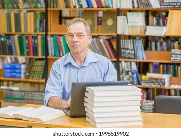 Happy Senior Man Using Laptop In Library.