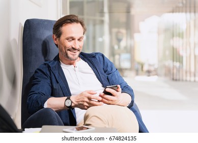 Happy Senior Man Using Mobile Phone