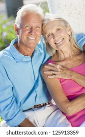 Happy Senior Man And Woman Couple Sitting Together Outside In Sunshine